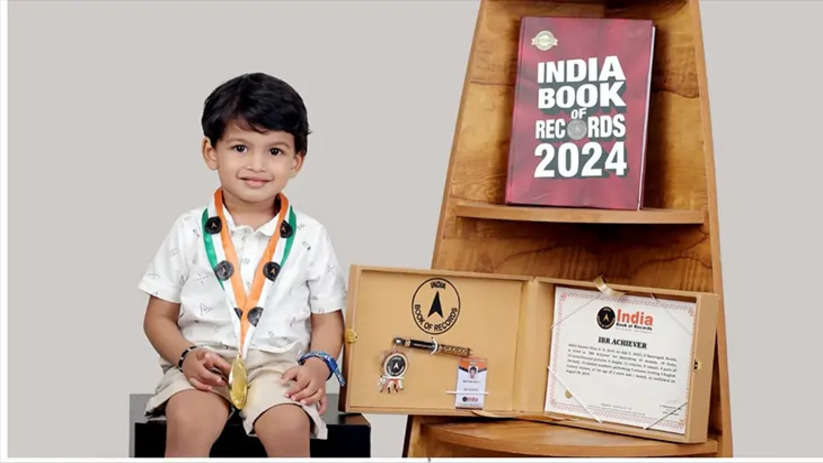 A 2-year-old boy, Abdul Samer Shan, from Kasaragod, holding a certificate.